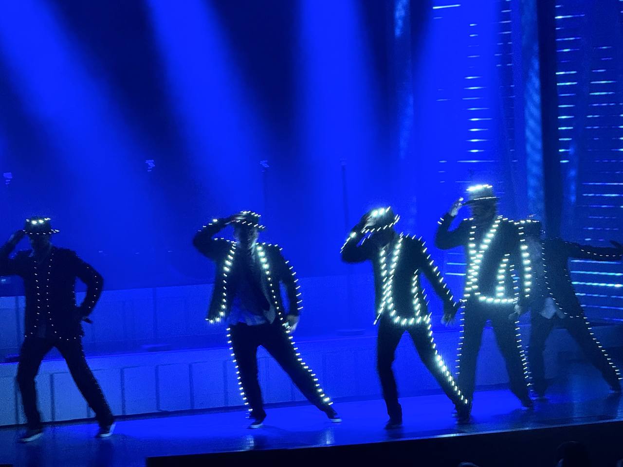 LED-lit dance troupe in blue light