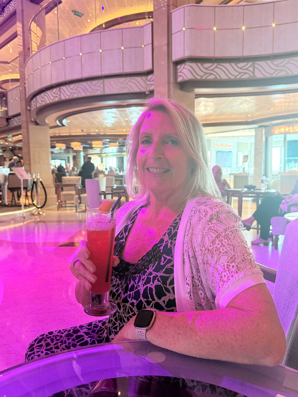 Woman in leopard print holding a red cocktail