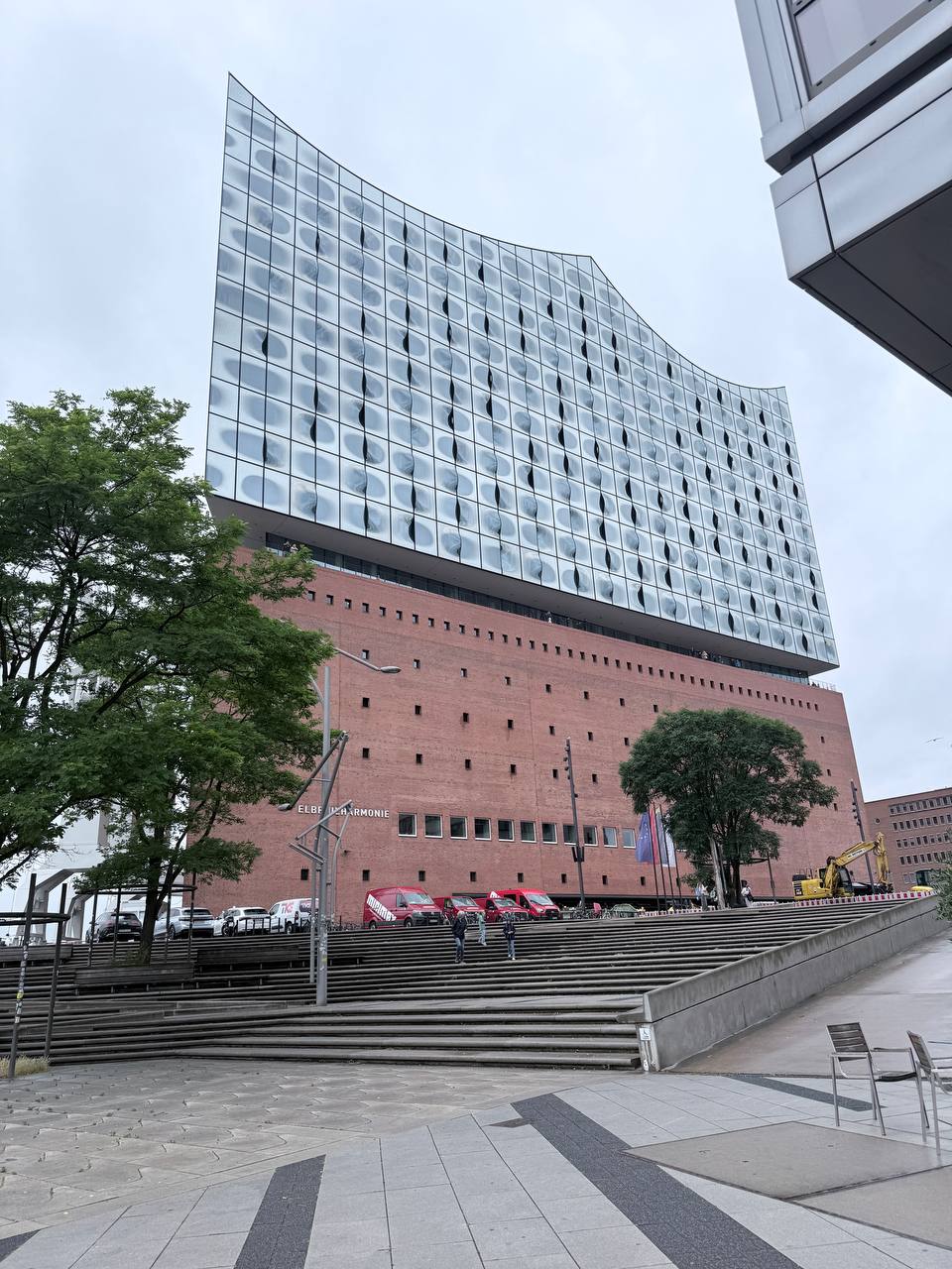 Elbphilharmonie concert hall with glass wave roof and brick base on overcast day