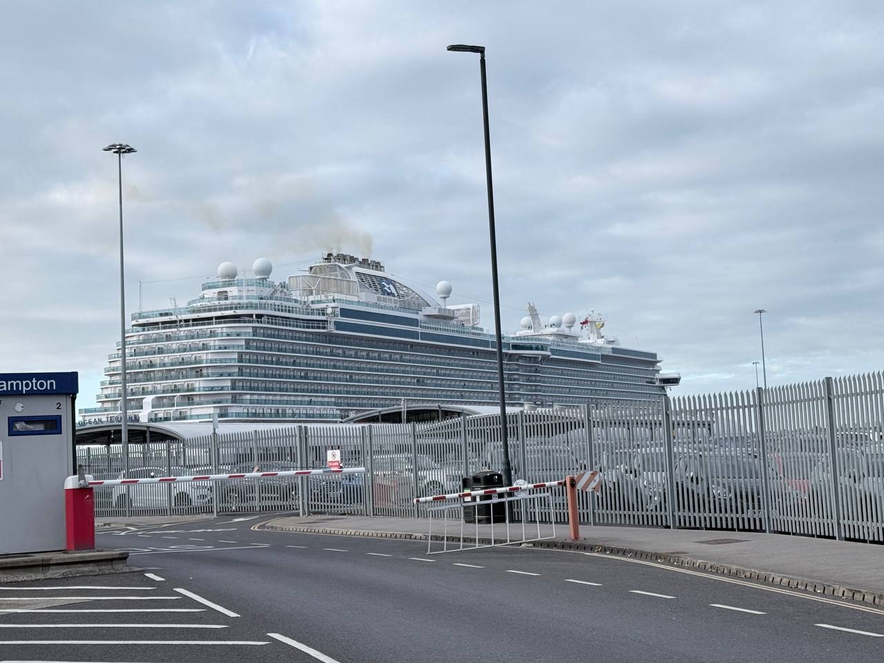 Majestic Princess cruise ship visible from the terminal road approaching security barriers