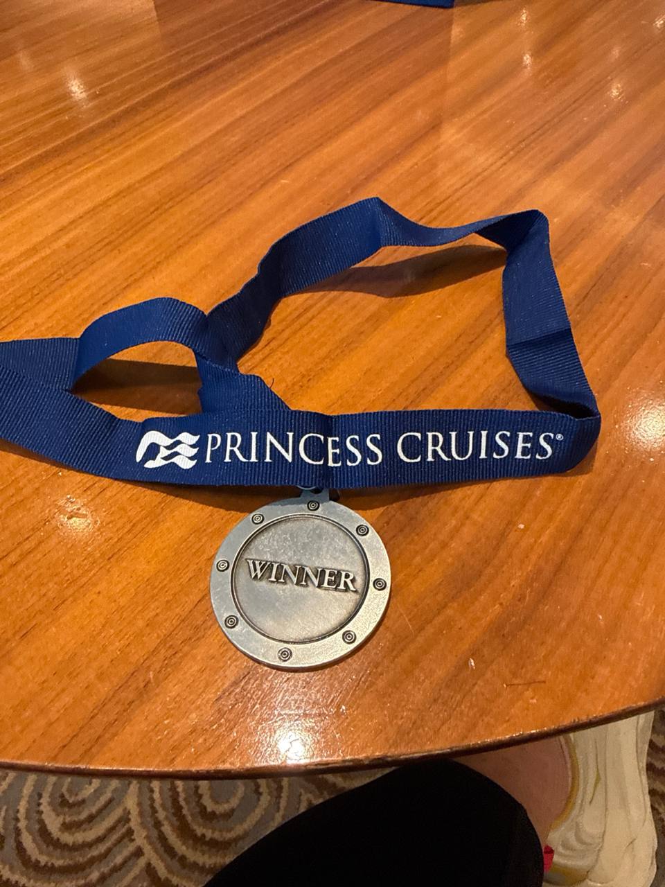 Prize medal on blue Princess Cruises ribbon