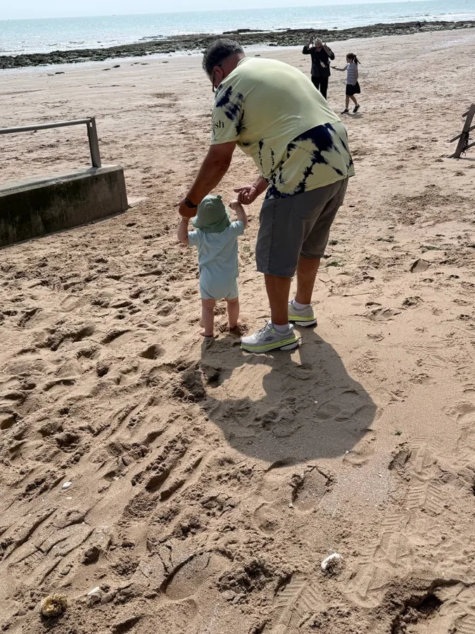Theo holding hands at Viking Bay beach, Broadstairs