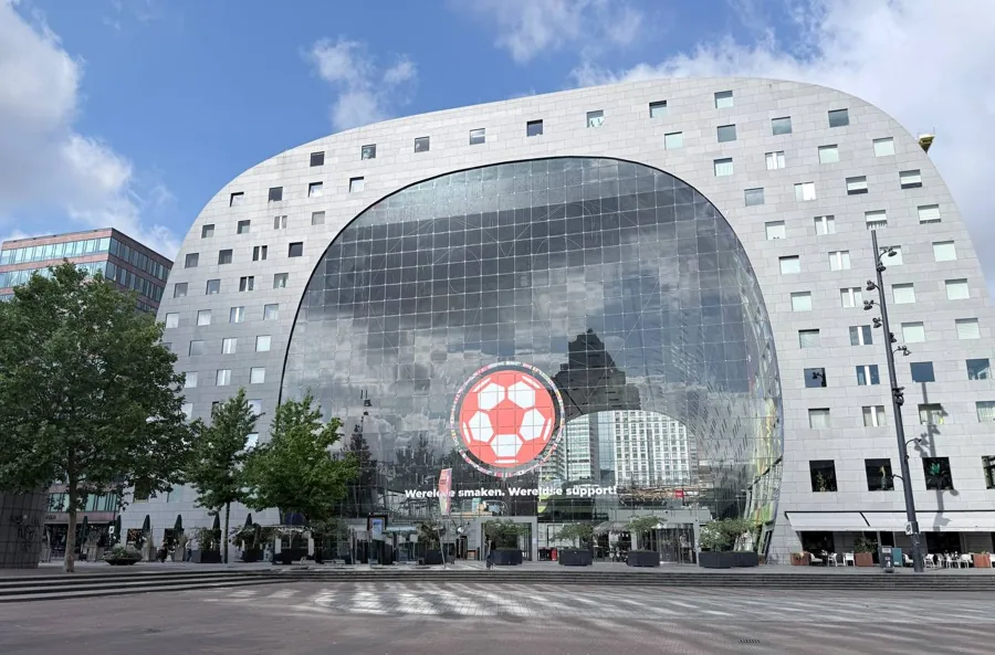 Interior of Markthal Rotterdam showing the colourful curved ceiling artwork