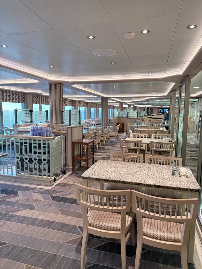 Dining room on the Majestic Princess with panoramic views across to the Rotterdam skyline through floor-to-ceiling windows