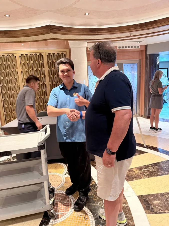 Handshake between passenger and cruise staff member