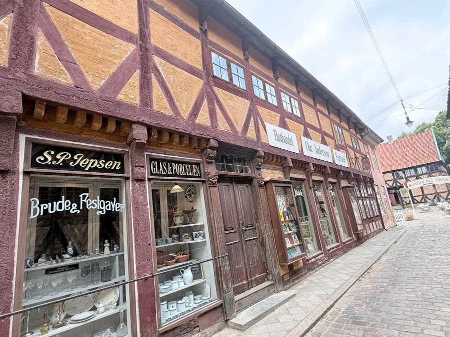 Historic half-timbered building with shops including S.P. Jepsen, Glas & Porcelan and Chr. Andersen Boghandel