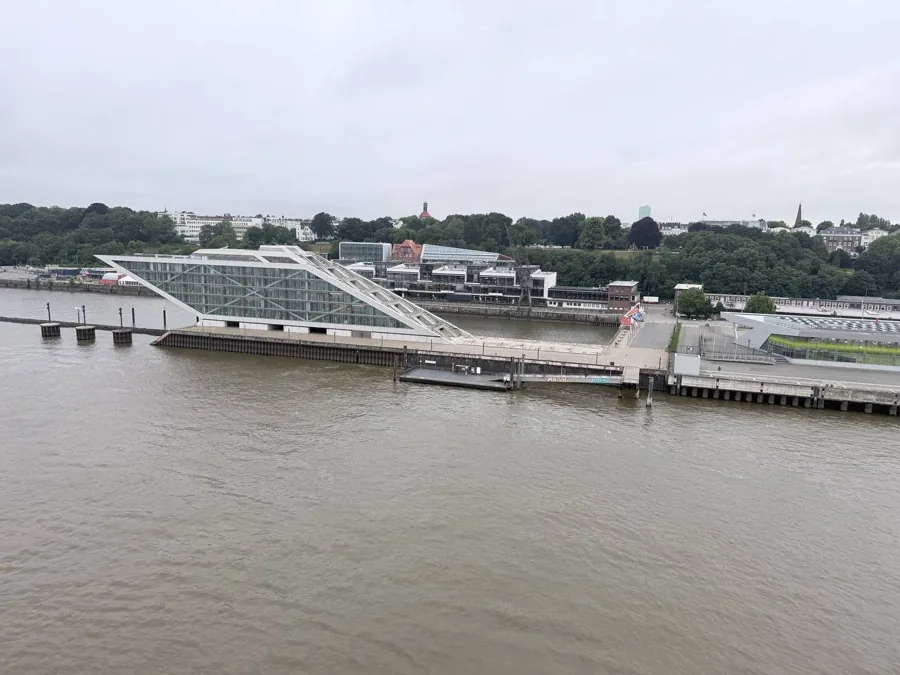Modern waterfront complex with angular white building on the river